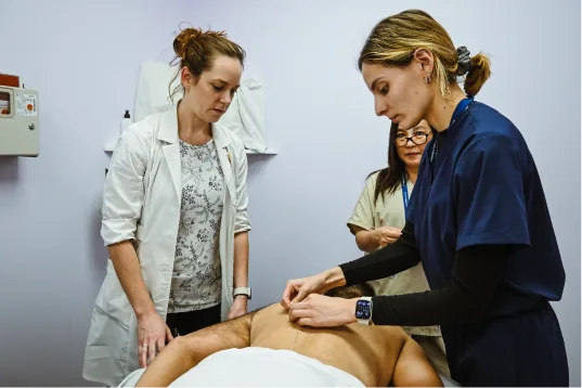 Students practicing acupuncture under faculty supervision